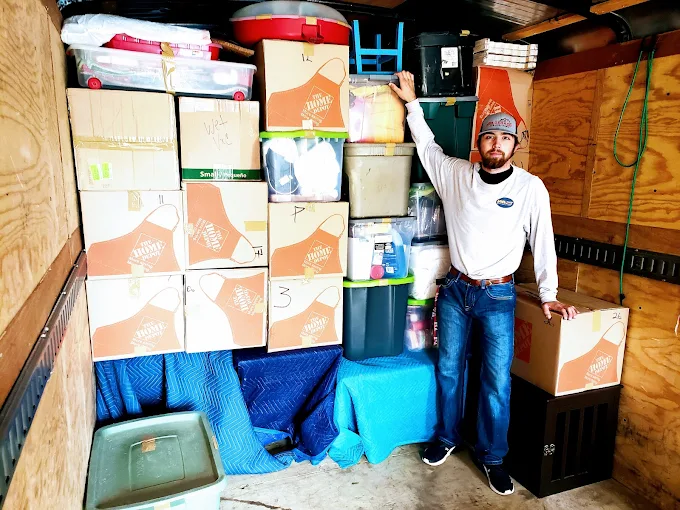 Completed junk removal job with professional team and trailer in Spring Texas showing transparent pricing